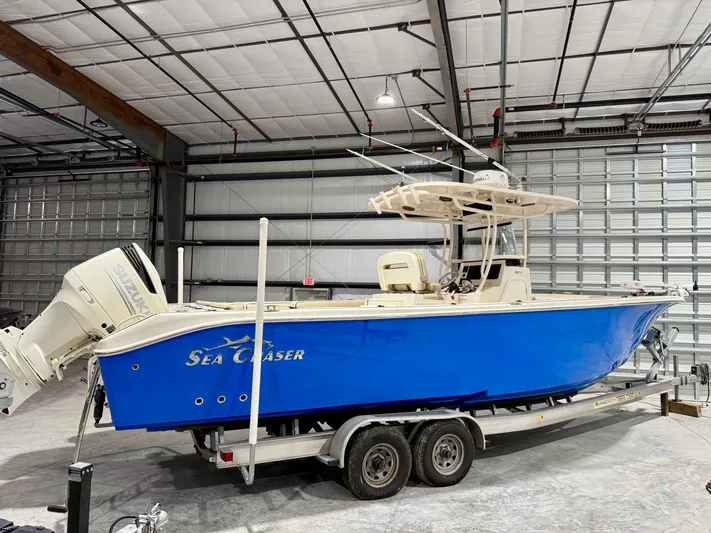  Yacht Photos Pics 2020 Sea Chaser 30 HFC CC boat in a warehouse, blue hull, on a trailer.