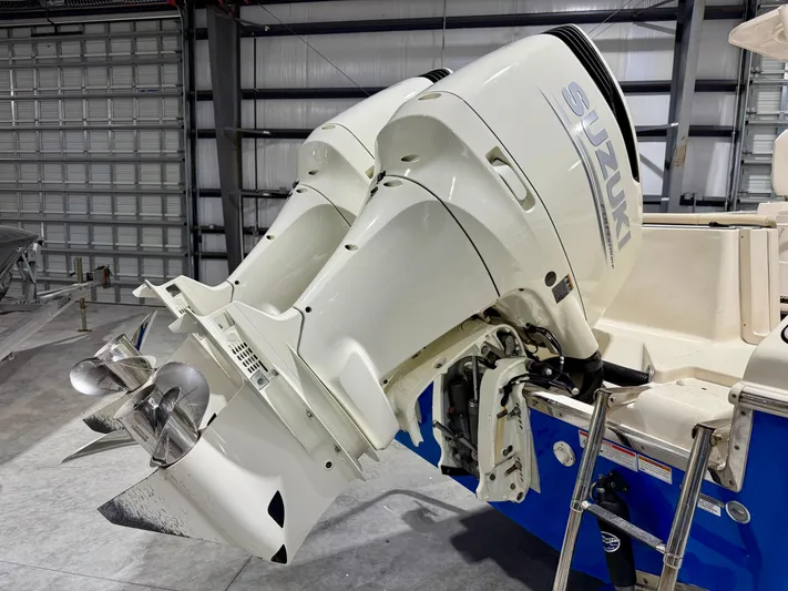  Yacht Photos Pics 2020 Sea Chaser 30 HFC CC boat with dual Suzuki outboard motors in a garage.