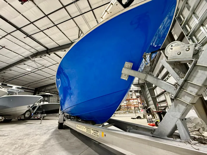  Yacht Photos Pics 2020 Sea Chaser 30 HFC CC boat in storage, vibrant blue hull on trailer.