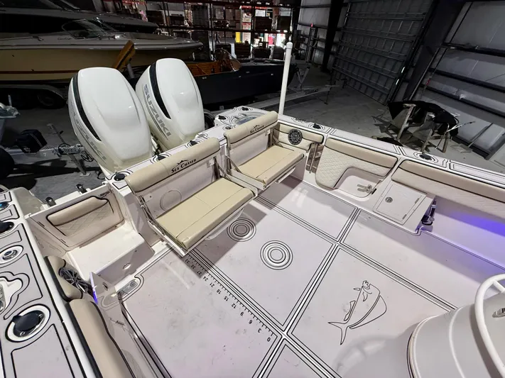  Yacht Photos Pics 2020 Sea Chaser 30 HFC CC boat interior with dual engines and seating in a garage.
