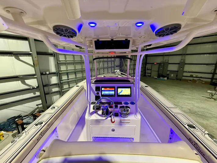  Yacht Photos Pics 2020 Sea Chaser 30 HFC CC boat interior with illuminated control panel in a warehouse.