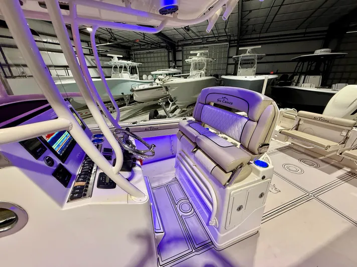  Yacht Photos Pics 2020 Sea Chaser 30 HFC CC boat interior with illuminated dashboard and seating in a showroom.