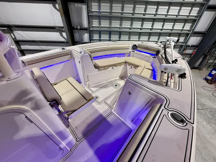  Yacht Photos Pics 2020 Sea Chaser 30 HFC CC boat interior with beige seating and blue LED lighting.