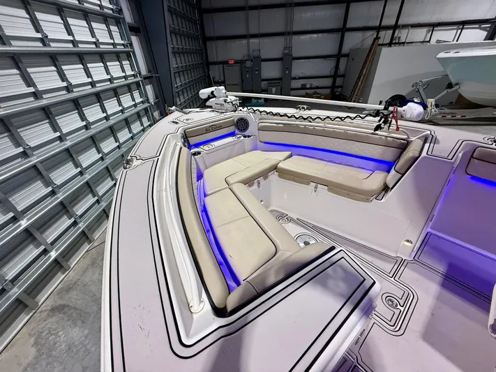  Yacht Photos Pics 2020 Sea Chaser 30 HFC CC boat interior with cushioned seating and blue LED lighting.