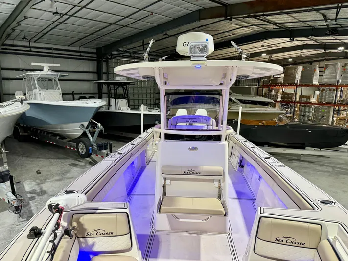  Yacht Photos Pics 2020 Sea Chaser 30 HFC CC boat in a warehouse, featuring blue interior lighting.