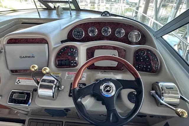  Yacht Photos Pics 2007 Sea Ray 340 Sundancer helm with Garmin navigation and classic wood-trimmed dashboard.