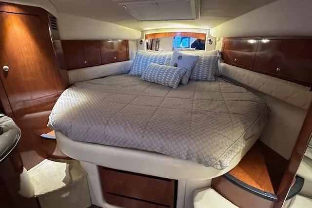  Yacht Photos Pics Luxurious cabin interior of 2007 Sea Ray 340 Sundancer with cozy bedding and wooden accents.