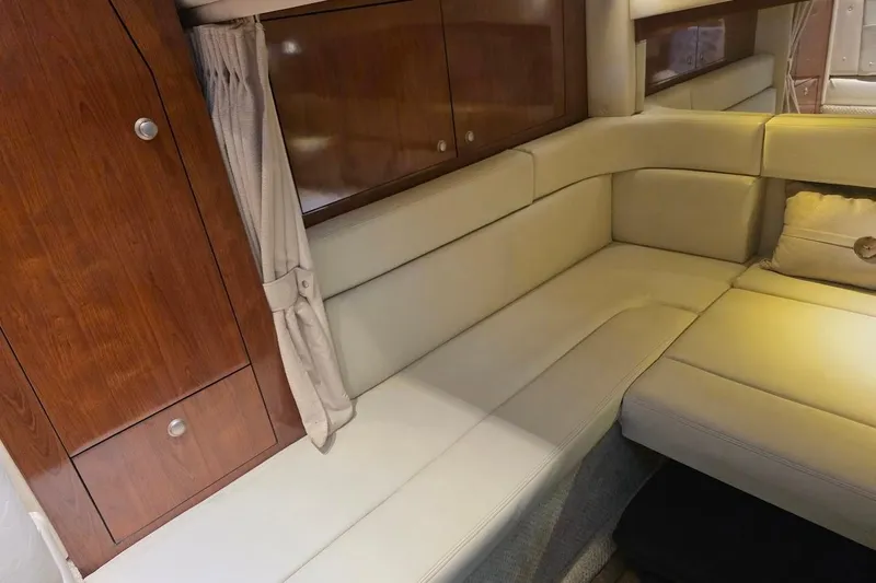  Yacht Photos Pics 2007 Sea Ray 340 Sundancer interior with beige seating and wooden cabinetry.