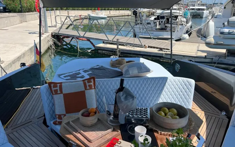  Yacht Photos Pics Luxurious 2019 Frauscher 1414 Demon yacht interior with elegant dining setup at marina.