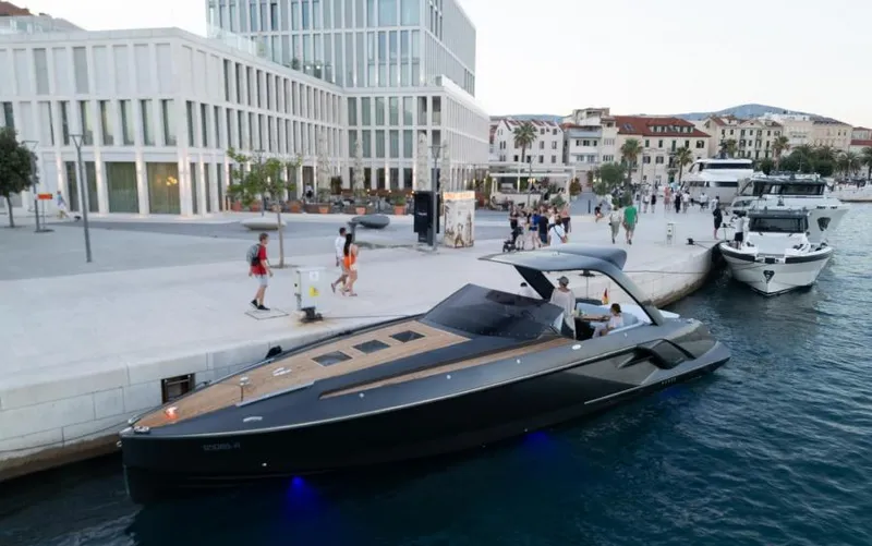  Yacht Photos Pics 2019 Frauscher 1414 Demon yacht docked in a modern marina setting.