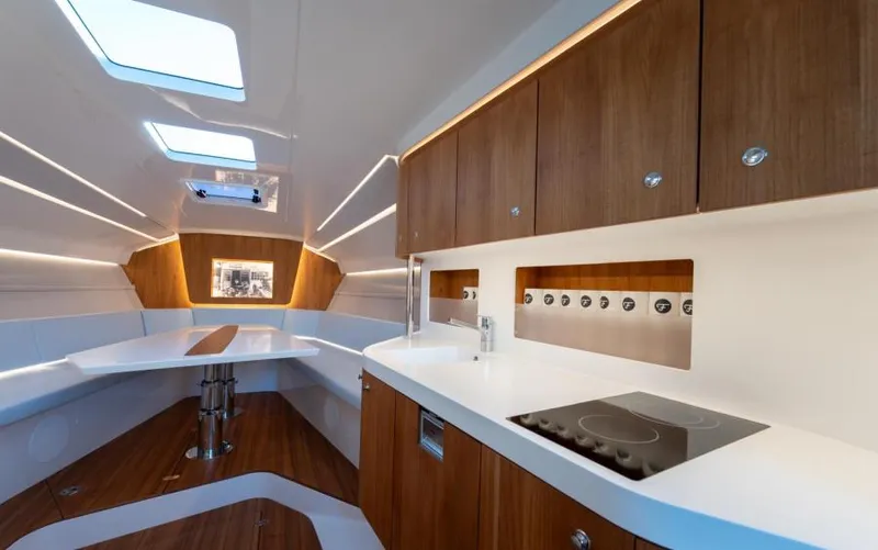  Yacht Photos Pics Luxurious interior of 2019 Frauscher 1414 Demon yacht with modern kitchen and seating area.
