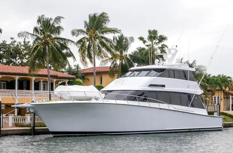 Chairman Yacht Photos Pics 1997 Palmer Johnson 80 Sportfish yacht docked near palm trees and waterfront homes.