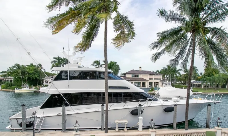 Chairman Yacht Photos Pics 1997 Palmer Johnson 80 Sportfish yacht docked by palm trees in a marina.