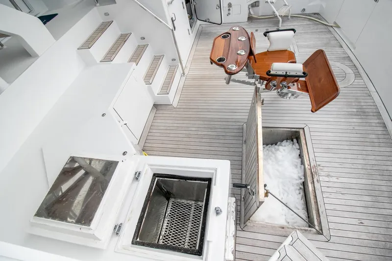Chairman Yacht Photos Pics Palmer Johnson 80 Sportfish M/Y 1997 yacht deck with fishing chair and storage compartments.