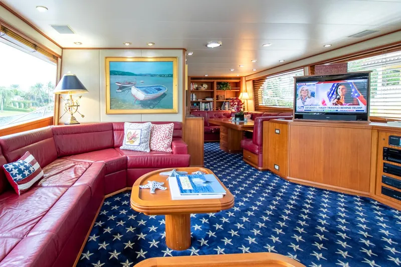 Chairman Yacht Photos Pics Luxurious interior of 1997 Palmer Johnson 80 Sportfish yacht with red leather seating and star-patterned carpet.