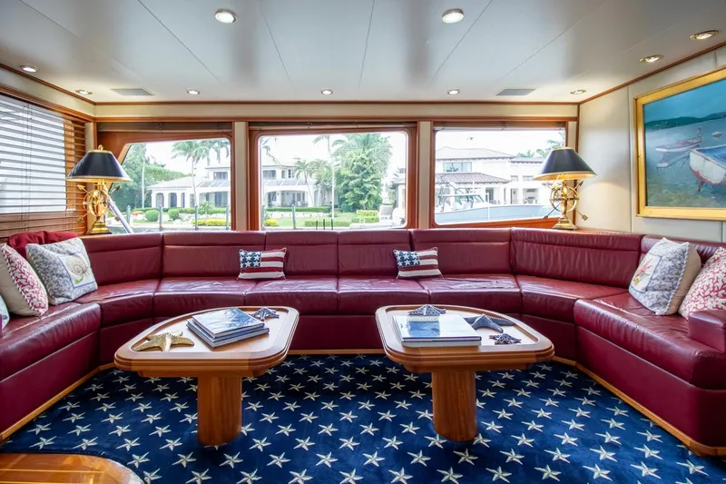 Chairman Yacht Photos Pics Luxurious yacht interior with red leather seating, star-patterned carpet, and large windows. Palmer Johnson 80 Sportfish M/Y.