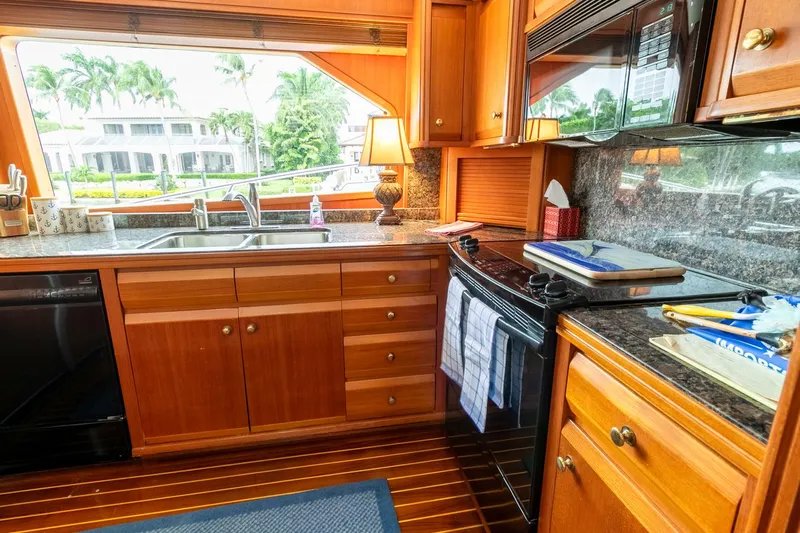 Chairman Yacht Photos Pics Luxurious kitchen interior of 1997 Palmer Johnson 80 Sportfish yacht with wooden cabinetry.
