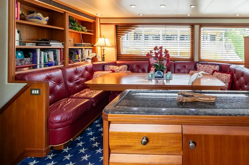 Chairman Yacht Photos Pics Luxurious interior of 1997 Palmer Johnson 80 Sportfish yacht with red leather seating and wooden accents.