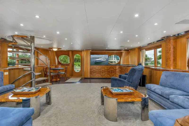 Boss Yacht Photos Pics Luxurious interior of 1989 Feadship 116 Sport Fisher yacht with elegant seating and spiral staircase.