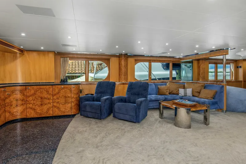 Boss Yacht Photos Pics Luxurious interior of 1989 Feadship 116 Sport Fisher yacht with plush seating and elegant wood finishes.