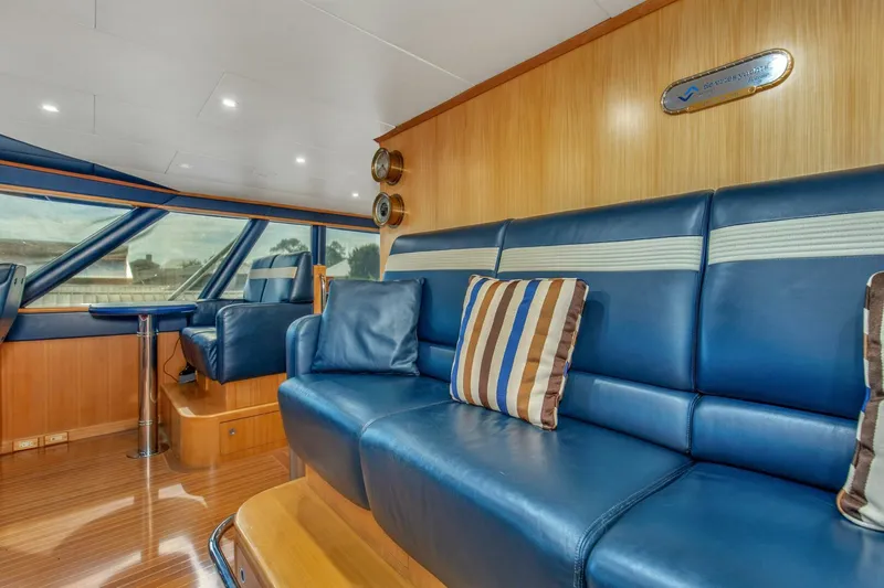 Boss Yacht Photos Pics Luxurious interior of 1989 Feadship 116 Sport Fisher yacht with blue leather seating.