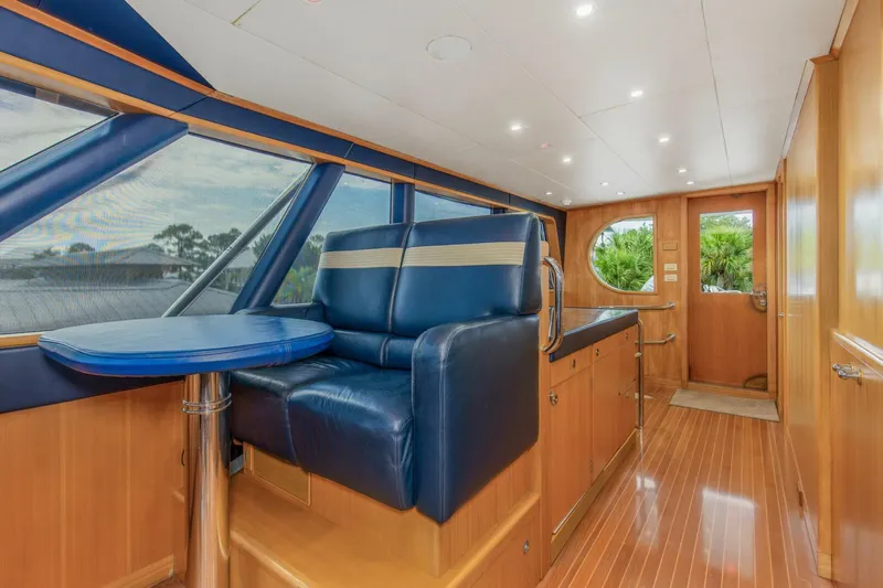 Boss Yacht Photos Pics Interior of 1989 Feadship 116 Sport Fisher yacht with blue seating and wooden finishes.
