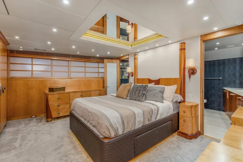 Boss Yacht Photos Pics Luxurious bedroom interior of 1989 Feadship 116 Sport Fisher yacht with elegant wood finishes.