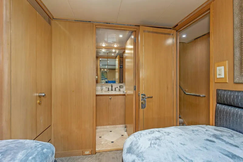 Boss Yacht Photos Pics Luxurious interior of 1989 Feadship 116 Sport Fisher yacht with wooden paneling and modern amenities.