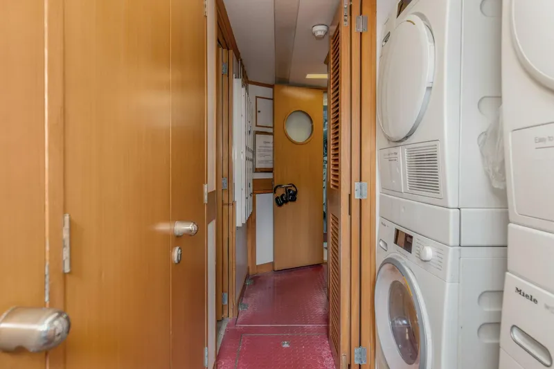 Boss Yacht Photos Pics Narrow hallway on 1989 Feadship 116 Sport Fisher with stacked washer and dryer.