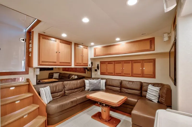 Reel Blessed Yacht Photos Pics Luxurious interior of a 2006 Cabo 52 Open yacht with leather seating and wooden cabinetry.