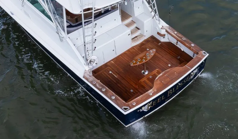 Reel Blessed Yacht Photos Pics 2006 Cabo 52 Open yacht with wooden deck, viewed from above, on water.