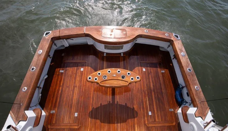 Reel Blessed Yacht Photos Pics 2006 Cabo 52 Open boat deck with polished wood finish and fishing rod holders.