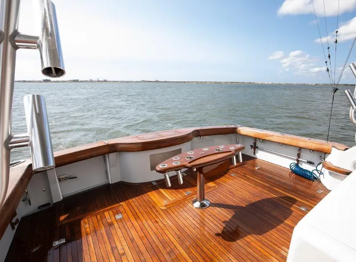 Reel Blessed Yacht Photos Pics Luxurious 2006 Cabo 52 Open yacht with polished wooden deck and ocean view.