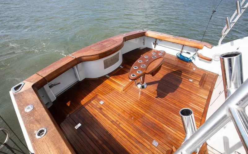 Reel Blessed Yacht Photos Pics 2006 Cabo 52 Open yacht deck with polished wood finish and fishing rod holders.