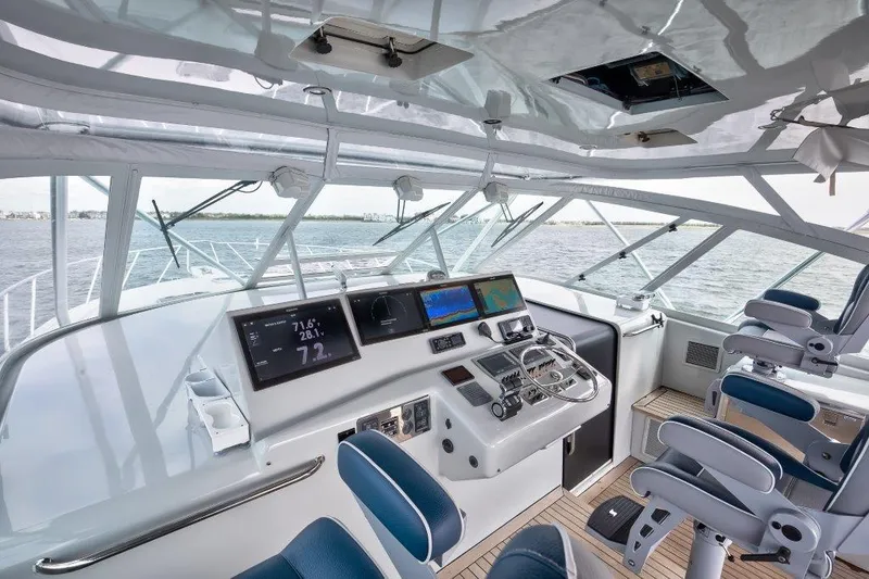 Reel Blessed Yacht Photos Pics Helm of 2006 Cabo 52 Open yacht with modern navigation equipment and ocean view.