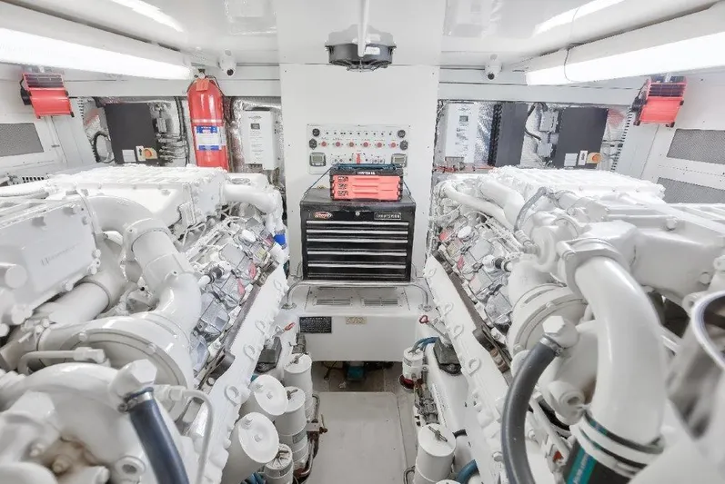Reel Blessed Yacht Photos Pics Engine room of a 2006 Cabo 52 Open yacht, featuring dual engines and control panel.