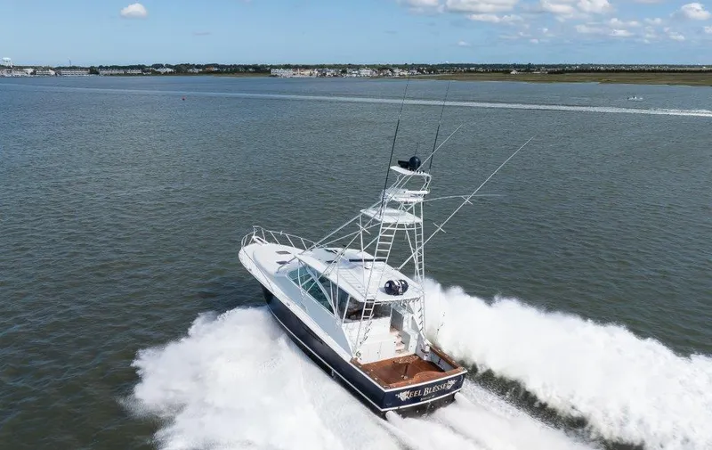 Reel Blessed Yacht Photos Pics 2006 Cabo 52 Open yacht cruising on open water, creating a dynamic wake.