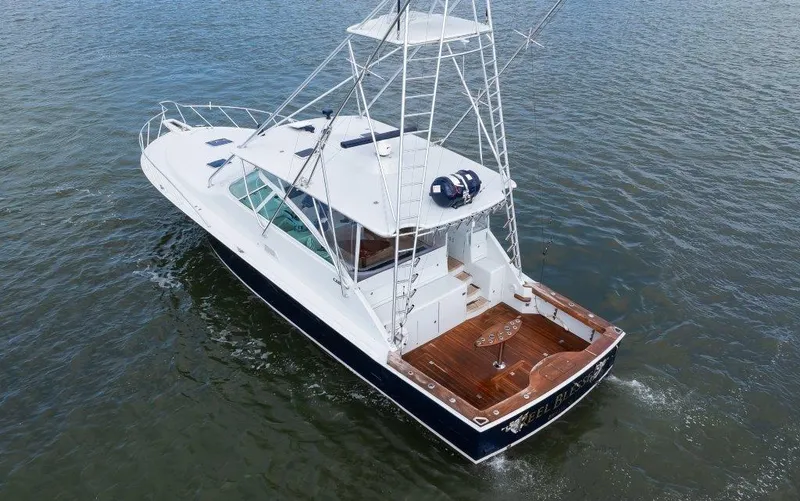 Reel Blessed Yacht Photos Pics 2006 Cabo 52 Open yacht cruising on open water, featuring a spacious deck and tower.