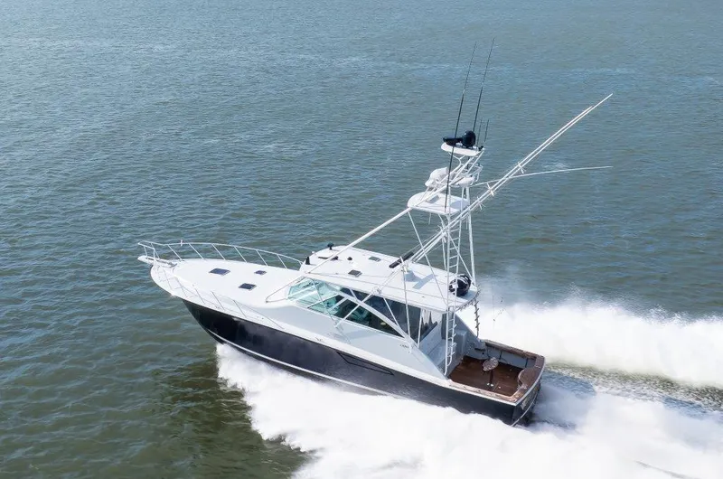 Reel Blessed Yacht Photos Pics 2006 Cabo 52 Open yacht cruising swiftly on open water.