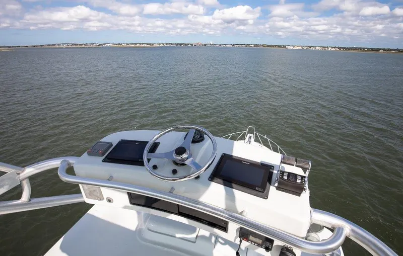 Reel Blessed Yacht Photos Pics Helm of 2006 Cabo 52 Open boat with ocean view and navigation equipment.