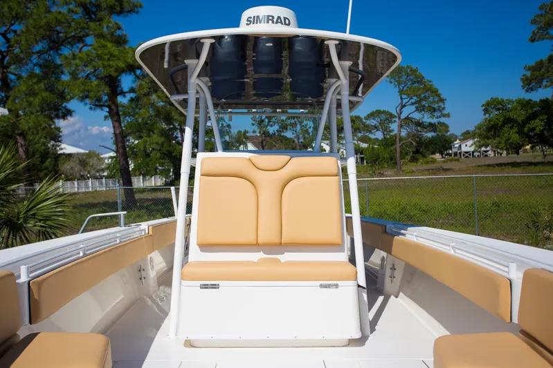  Yacht Photos Pics 2012 Contender 39 LS boat with tan seating and Simrad electronics, docked outdoors.