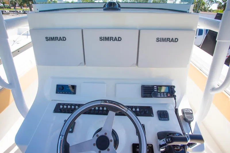  Yacht Photos Pics Contender 39 LS 2012 boat dashboard with Simrad displays and steering wheel.