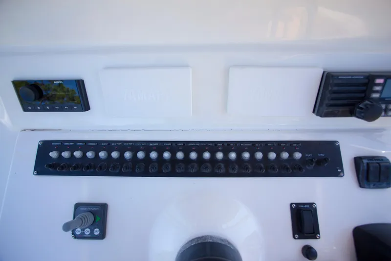  Yacht Photos Pics Control panel of a 2012 Contender 39 LS boat with various switches and displays.