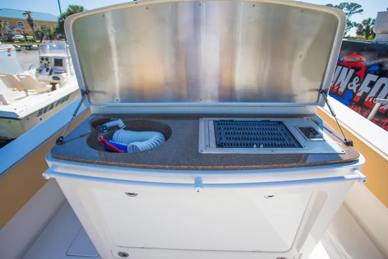  Yacht Photos Pics Outdoor kitchen setup on a 2012 Contender 39 LS boat with grill and sink.