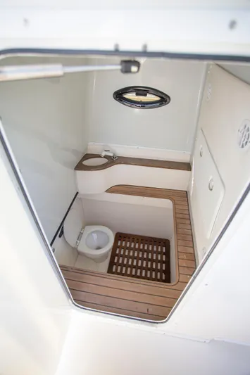  Yacht Photos Pics 2012 Contender 39 LS boat interior with wooden flooring and compact bathroom.