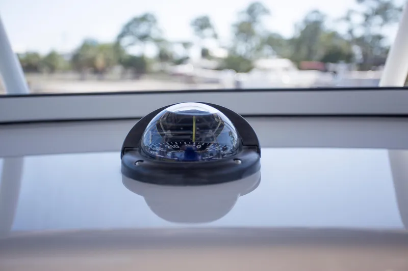  Yacht Photos Pics Compass on Contender 39 LS boat dashboard, 2012 model, with blurred outdoor background.