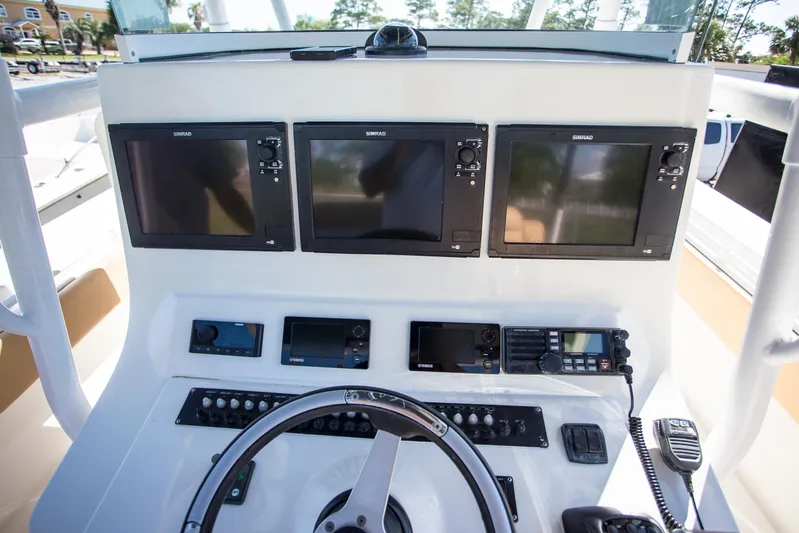  Yacht Photos Pics Control panel of 2012 Contender 39 LS boat with multiple screens and navigation equipment.
