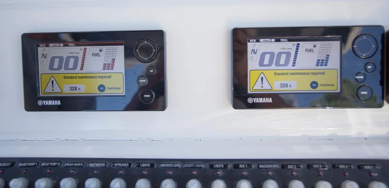  Yacht Photos Pics Yamaha boat control panels on a 2012 Contender 39 LS, displaying maintenance alerts.