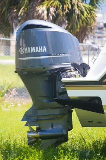  Yacht Photos Pics Yamaha outboard motor on 2012 Contender 39 LS boat, parked on grass.