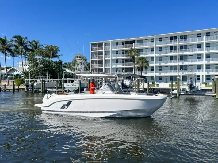  Yacht Photos Pics 2024 Beneteau Flyer 9 SPACEdeck boat on water near waterfront building.